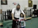 Channie Jalusi gives Rabbi his new bicycle